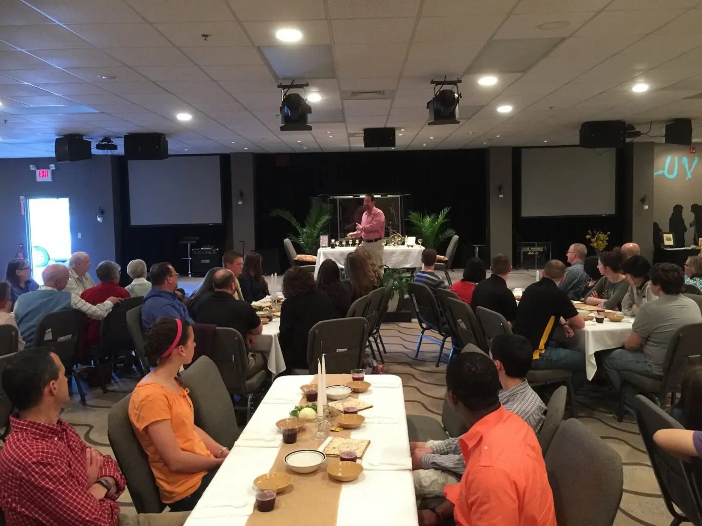A group of people sitting at tables in a room.