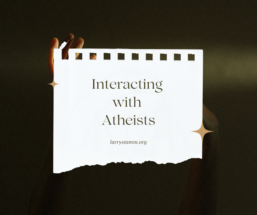Hands holding a sign about atheism.