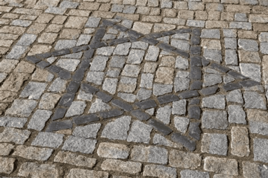 A huge star on pavement made of bricks of darker color