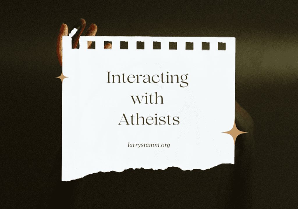 Hands holding a sign about atheism.