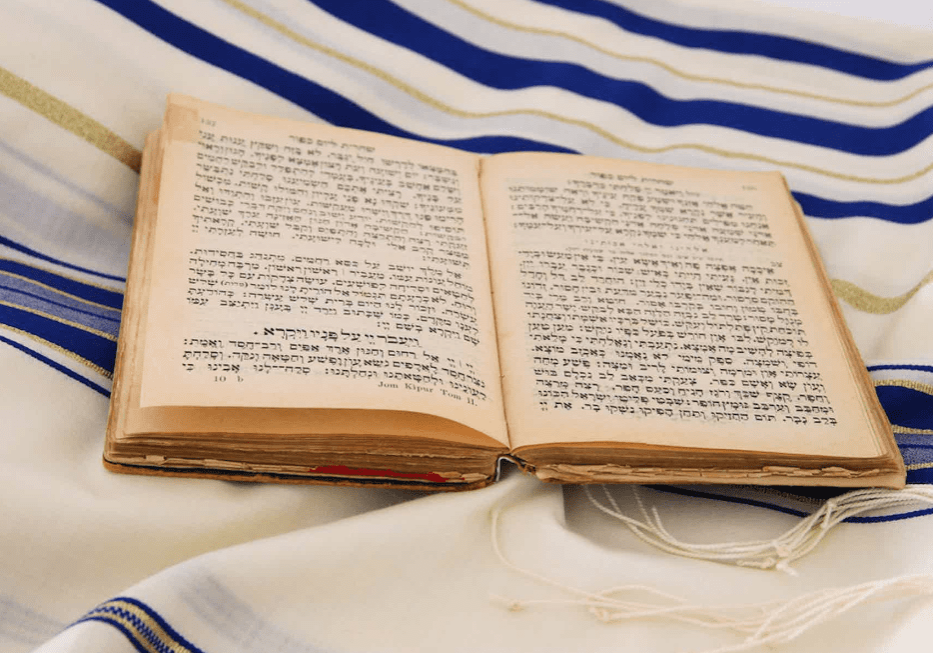 An open book on a white and blue striped cloth.