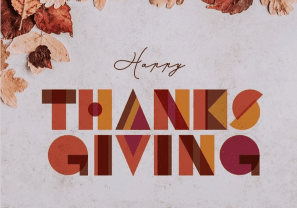 A Happy Thanksgiving poster with leaves on top